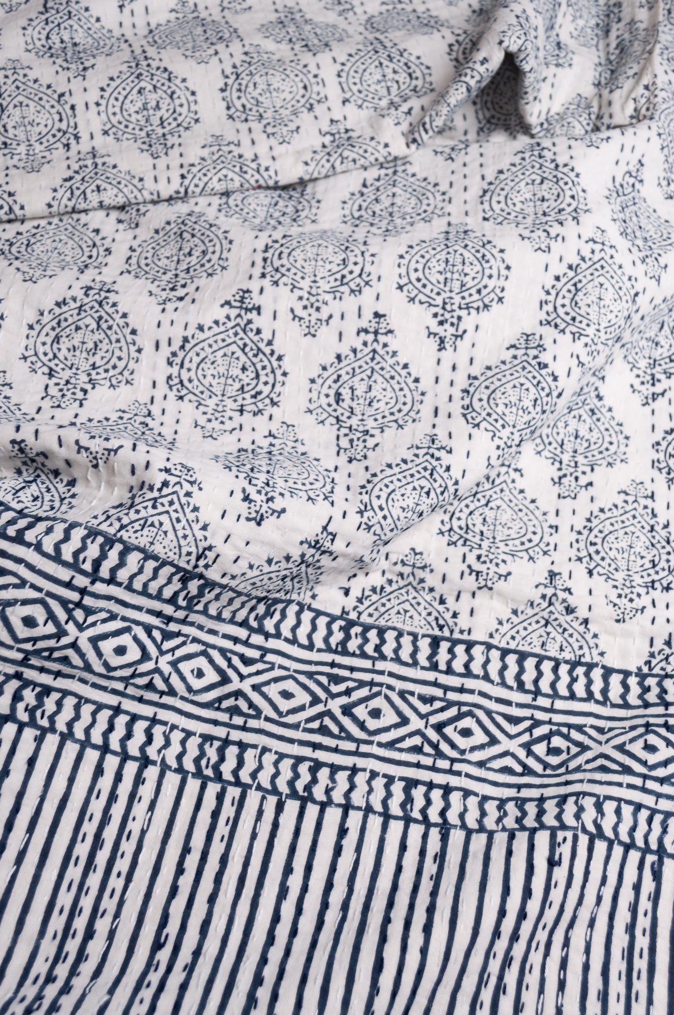 Blue and white mogul print cotton kantha quilt.