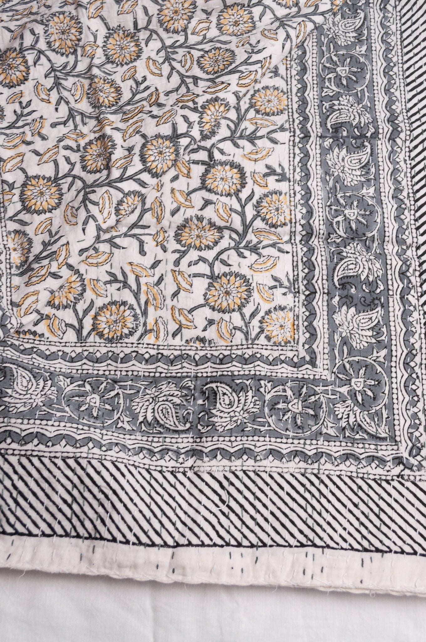 Hand stitched block print pure cotton kantha quilt silver grey and mustard gold floral and vine on white.