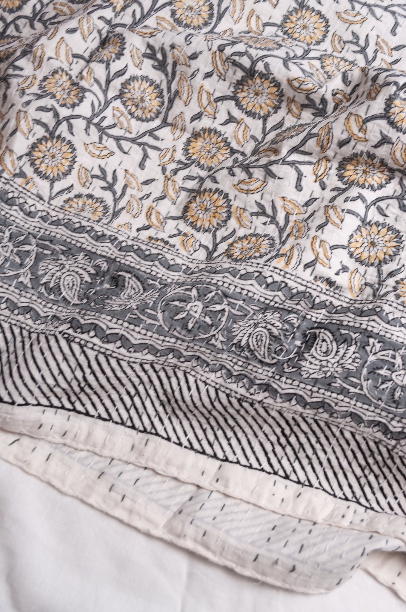 Hand stitched block print pure cotton kantha quilt silver grey and mustard gold floral and vine on white.