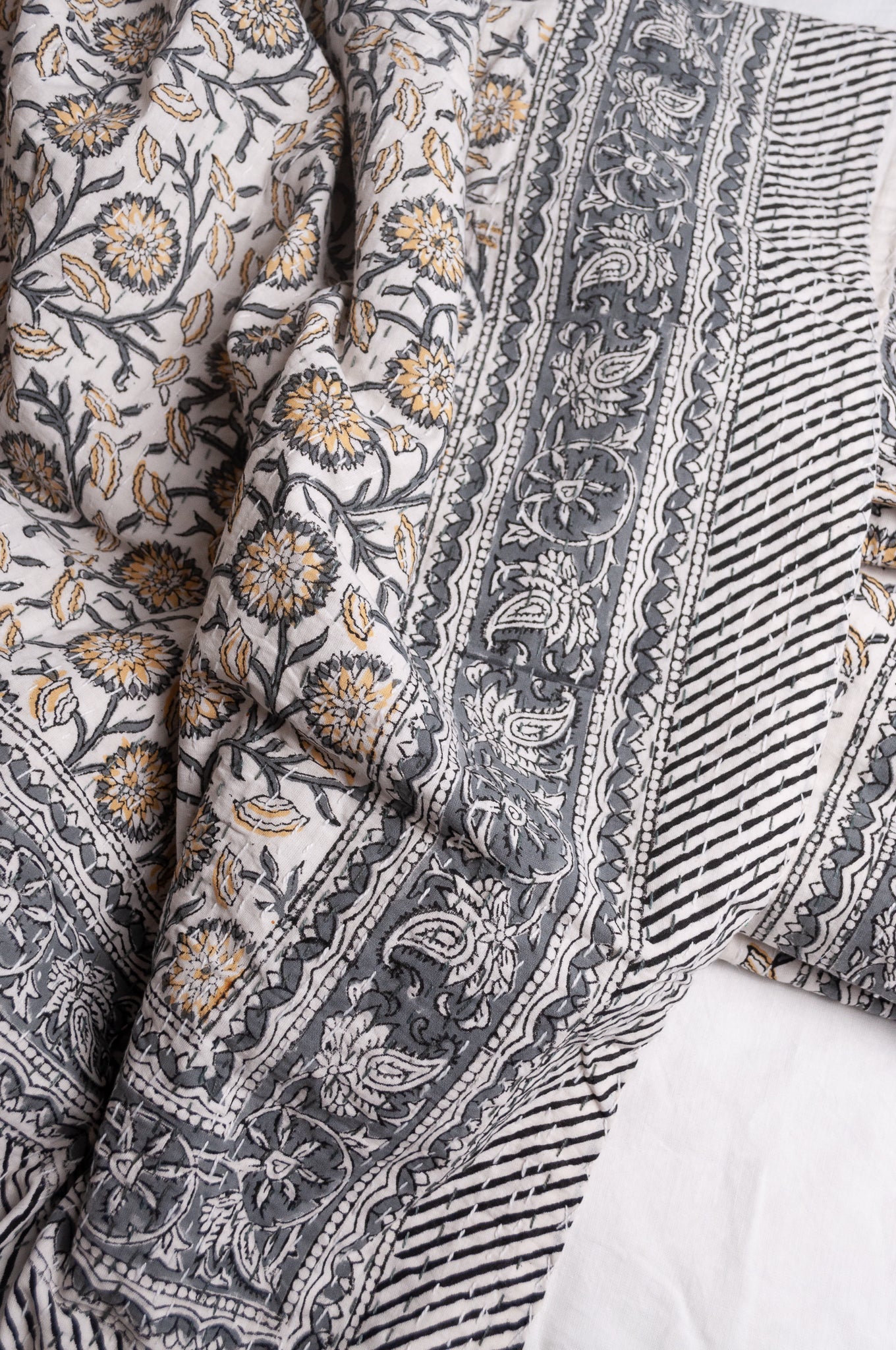 Hand stitched block print pure cotton kantha quilt silver grey and mustard gold floral and vine on white.