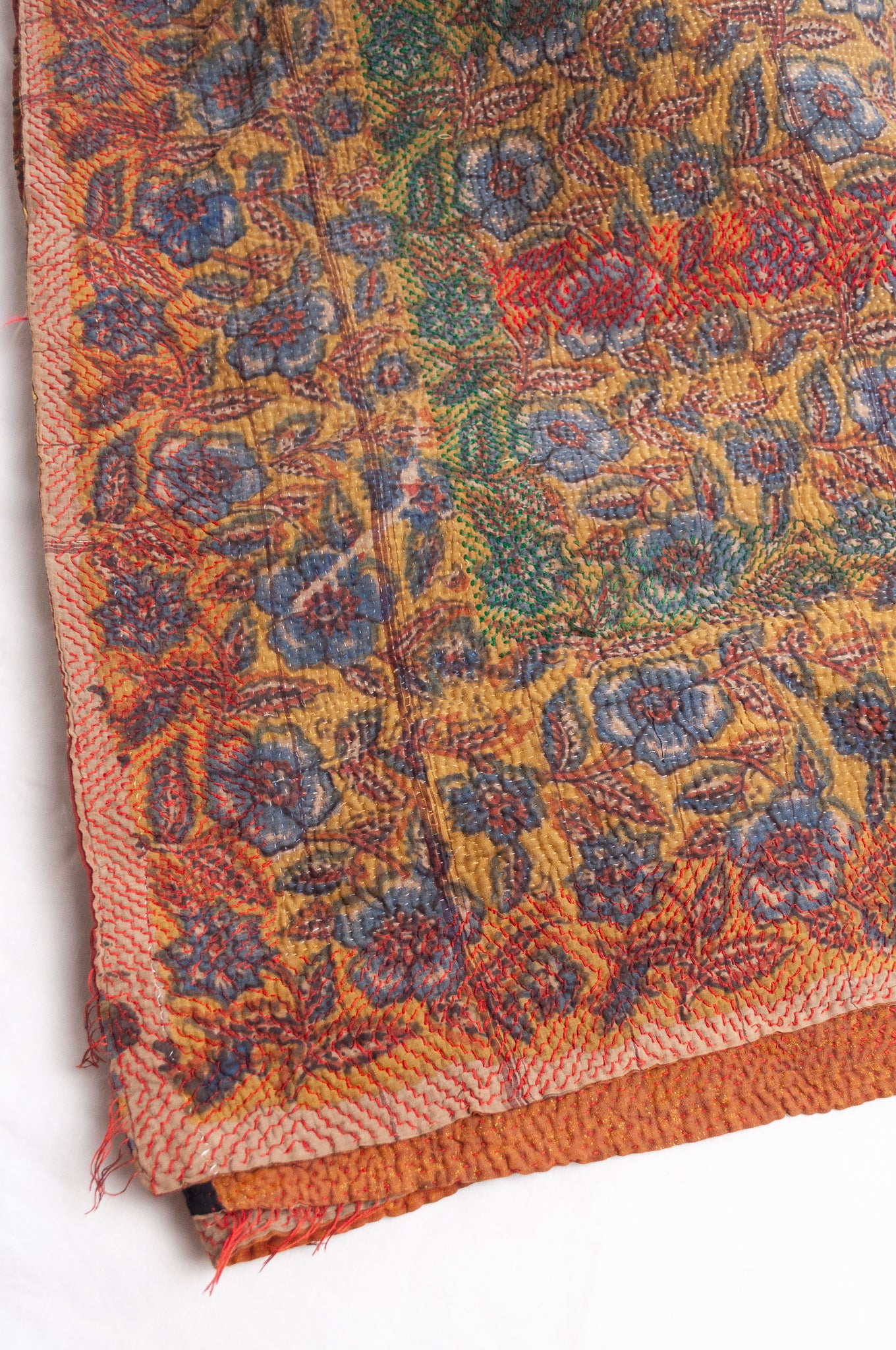 Bagru overdye blockprint vintage kantha quilt in rust red and denim blue on mustard and olive.