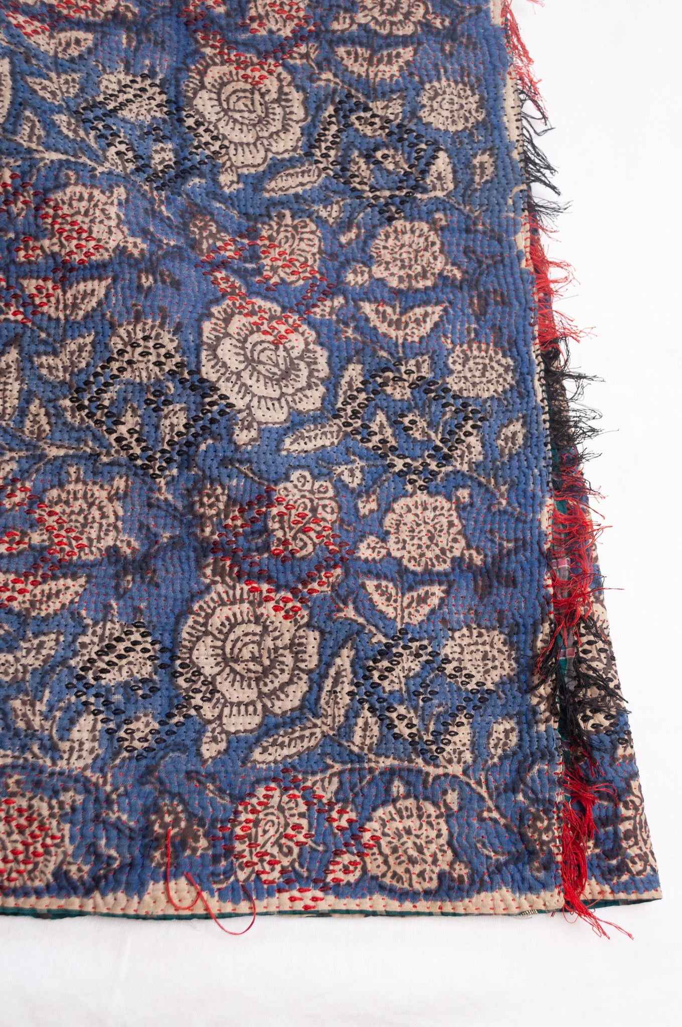 Bagru over print vintage blockprint kantha quilt, floral on denim blue with red embroidery and green plaid reverse.