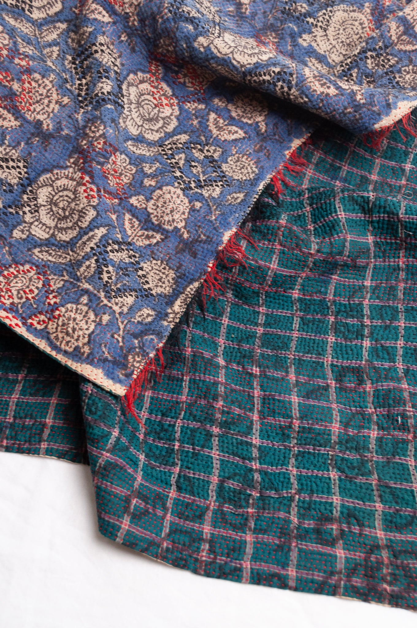 Bagru over print vintage blockprint kantha quilt, floral on denim blue with red embroidery and green plaid reverse.