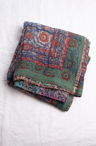 Bagru overdye blockprint vintage kantha quilt in red, ecru and denim blue with green borders.