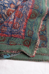 Bagru overdye blockprint vintage kantha quilt in red, ecru and denim blue with green borders.