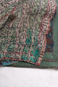 Bagru overdye blockprint vintage kantha quilt in red, ecru and denim blue with green borders.