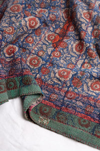 Bagru overdye blockprint vintage kantha quilt in red, ecru and denim blue with green borders.