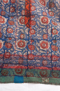 Bagru overdye blockprint vintage kantha quilt in red, ecru and denim blue with green borders.