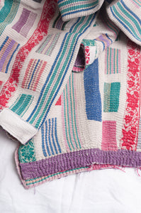 Multi colour patched white vintage kantha quilt.