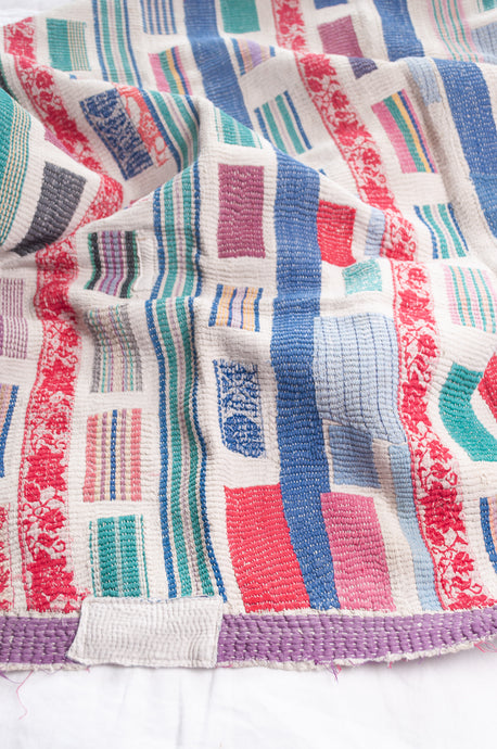 Multi colour patched white vintage kantha quilt.