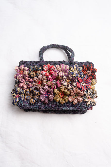 Sophie Digard hand crocheted raffia bag flowers in bright pastels.