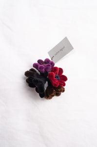 Sophie Digard velour flower jonquille brooch in deep wintery tones.