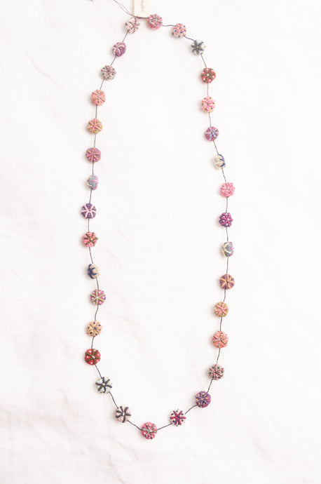 Sophie Digard embroidered linen beads in bright pastel tones.