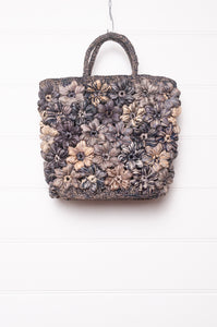 Sophie Digard croceht raffia bag with flowers in shades of blues and grey.