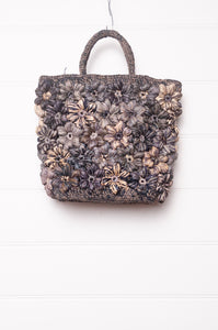 Sophie Digard croceht raffia bag with flowers in shades of blues and grey.