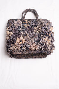 Sophie Digard croceht raffia bag with flowers in shades of blues and grey.