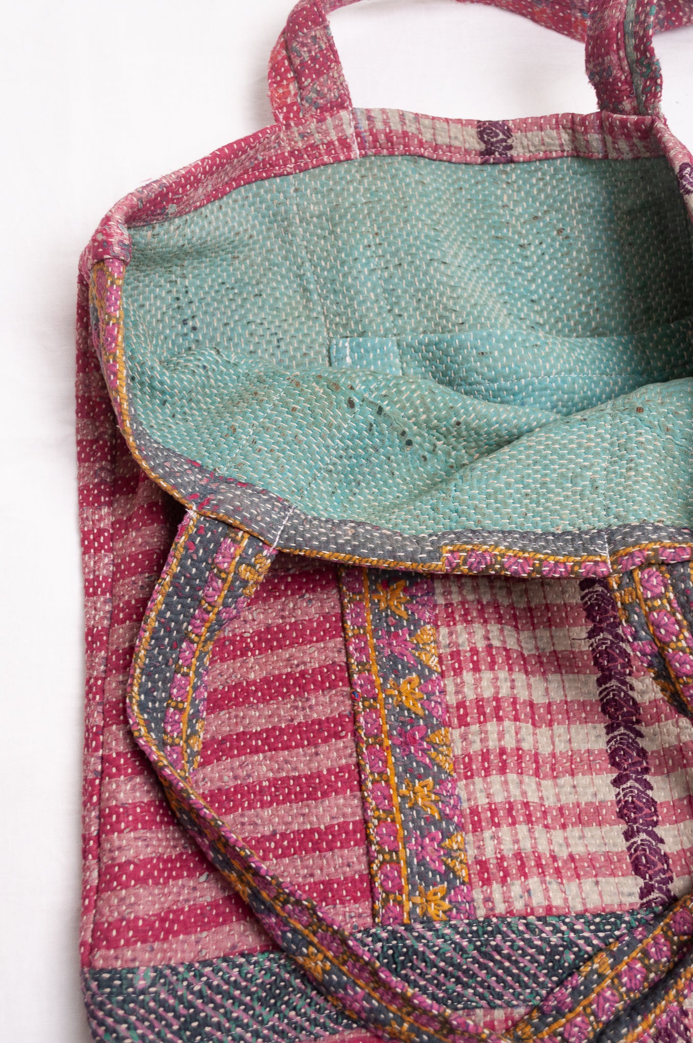 Vintage kantha quilt tote bag in deep rose pink stripe and floral pattern.