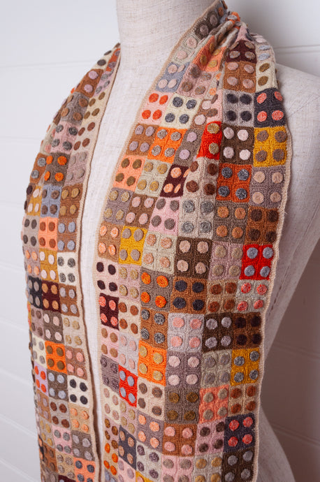 Sophie Digard crochet wool scarf tiny squares with spots in warm earthy tones.