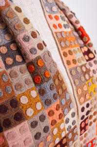 Sophie Digard crochet wool scarf tiny squares with spots in warm earthy tones.