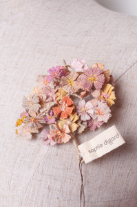 Sophie Digard crocheted flower brooch in warm neutral tones.