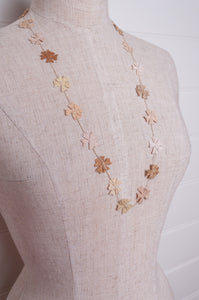 Sophie Digard fine crochet flower necklace in natural tones.