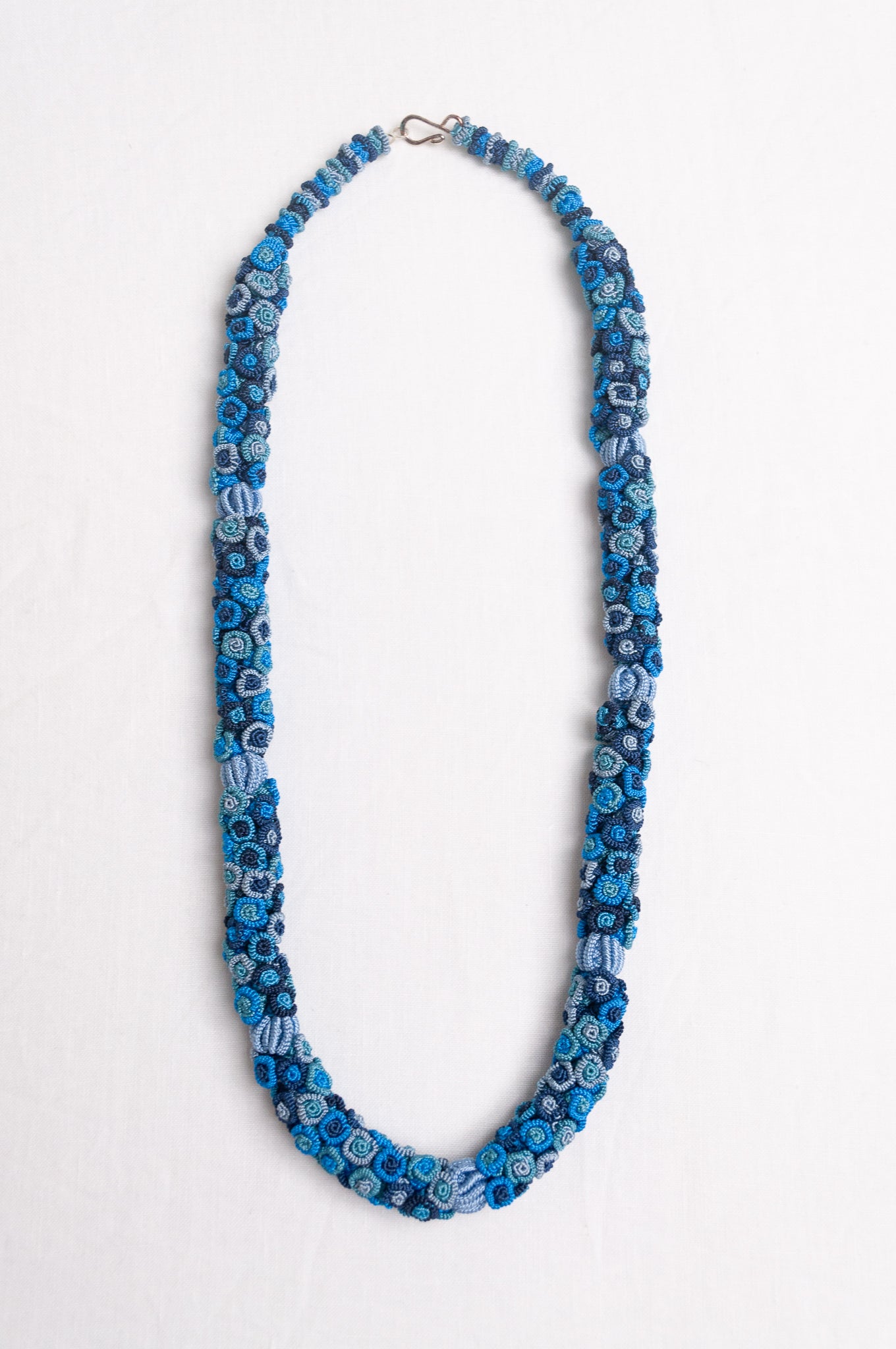 Clustered Moroccan flower button necklace in blues.