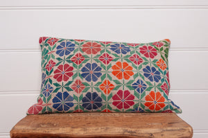 Vintage cross stitch bright floral bolster cushion.