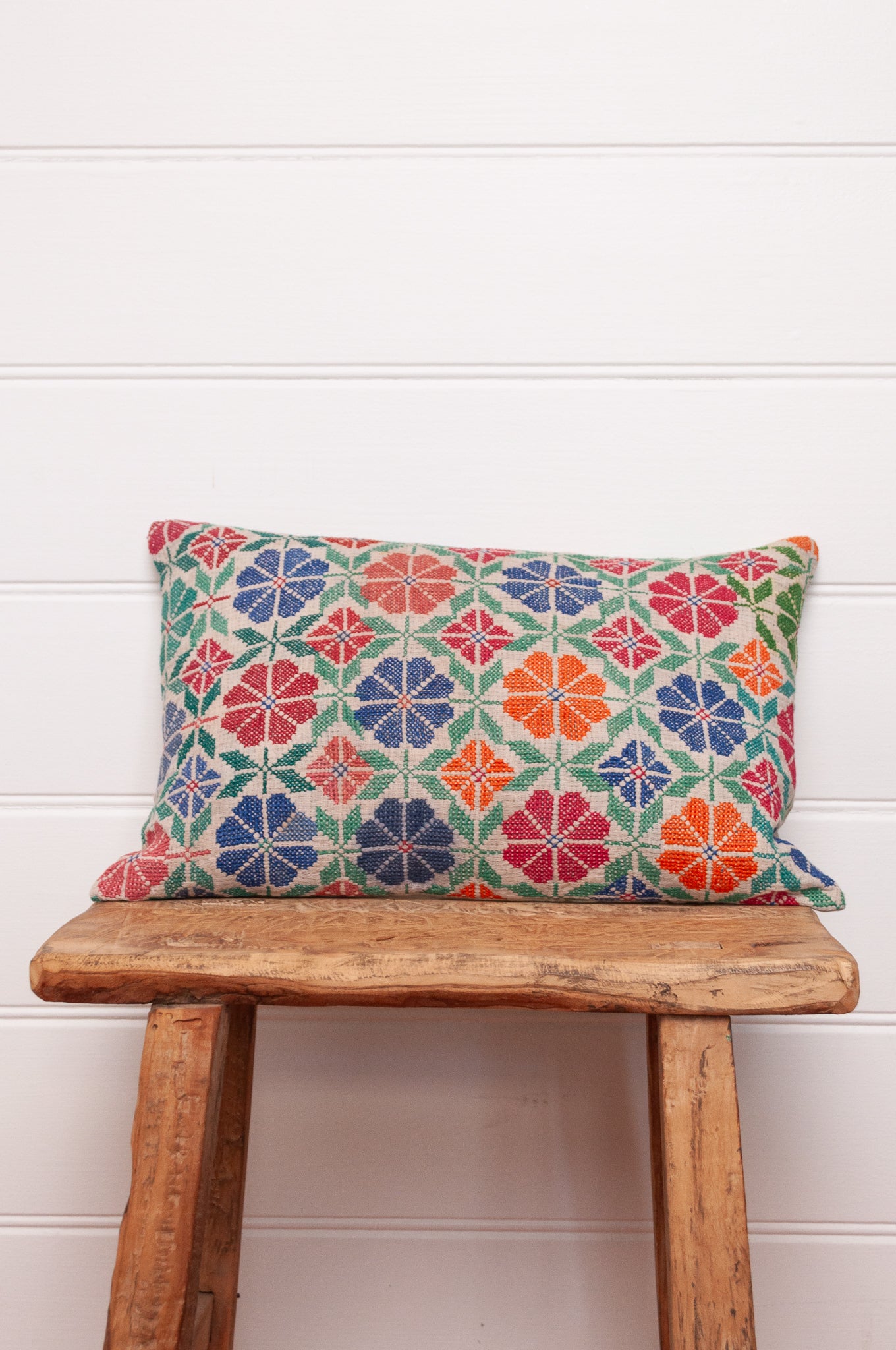 Vintage cross stitch bright floral bolster cushion.