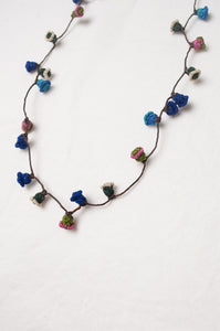 Moroccan flower button necklace in cornflower blues and pink.