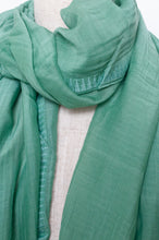 Load image into Gallery viewer, Silk and cotton scarf with pom poms in aqua green.