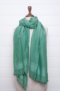 Silk and cotton scarf with pom poms in aqua green.