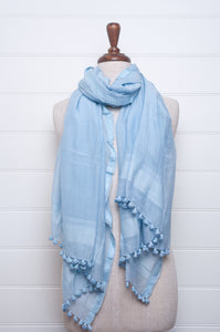 Silk and cotton scarf with pom poms in sky blue.