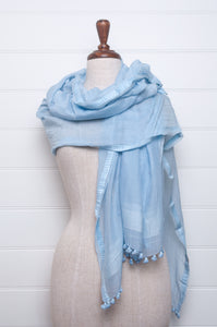 Silk and cotton scarf with pom poms in sky blue.