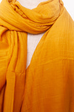 Load image into Gallery viewer, Silk and cotton scarf with pom poms in golden yellow.