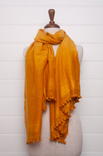 Load image into Gallery viewer, Silk and cotton scarf with pom poms in golden yellow.