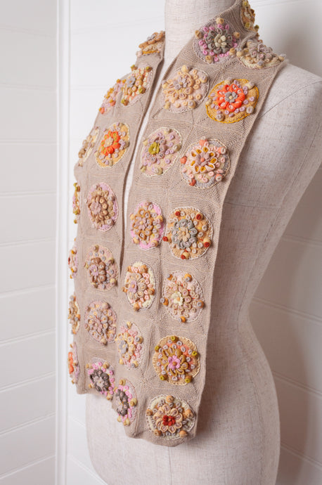 Sophie Digard crocheted scarf with embroidered and crocheted medallions in warm neutral tones.