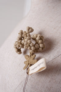 Handcrafted brooch by Sophie Digard, featuring embroidered flowers in thyme green linen.