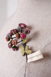 Handcrafted brooch by Sophie Digard, featuring small embroidered button flowers in linen.