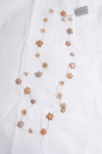 Sophie Digard star flower embroidered linen necklace in warm neutrals.