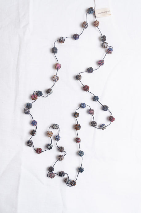 Sophie Digard linen bead hand embroidered necklace in blues, browns and pinks.