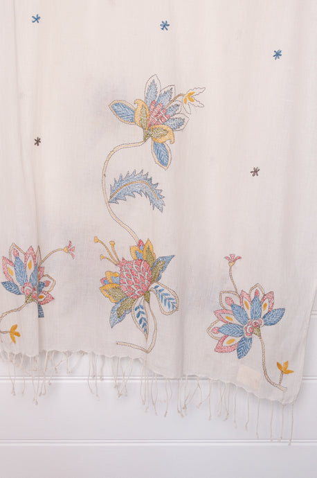 Khadi cotton hand embroidered scarf with blue and red and yellow flowers.