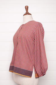 Handloom check cotton button up round neck blouse with long sleeves and selvedge hem detail.