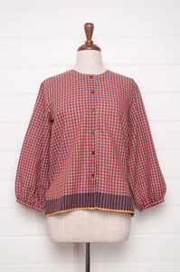 Handloom check cotton button up round neck blouse with long sleeves and selvedge hem detail.