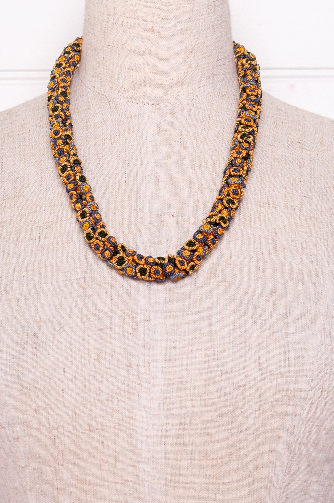 Moroccan flower button Oznati necklace in mustard yellow, latte and grey.