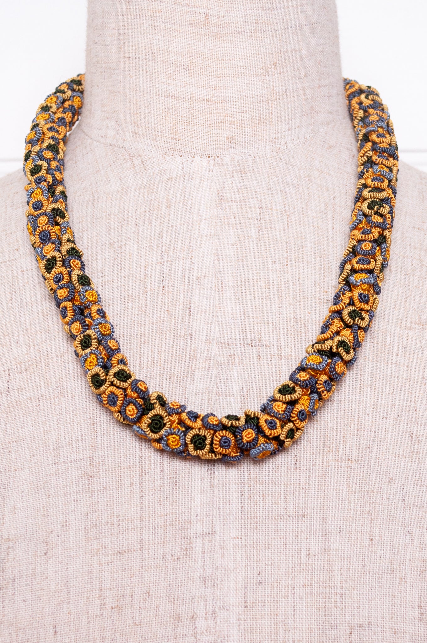 Moroccan flower button Oznati necklace in mustard yellow, latte and grey.