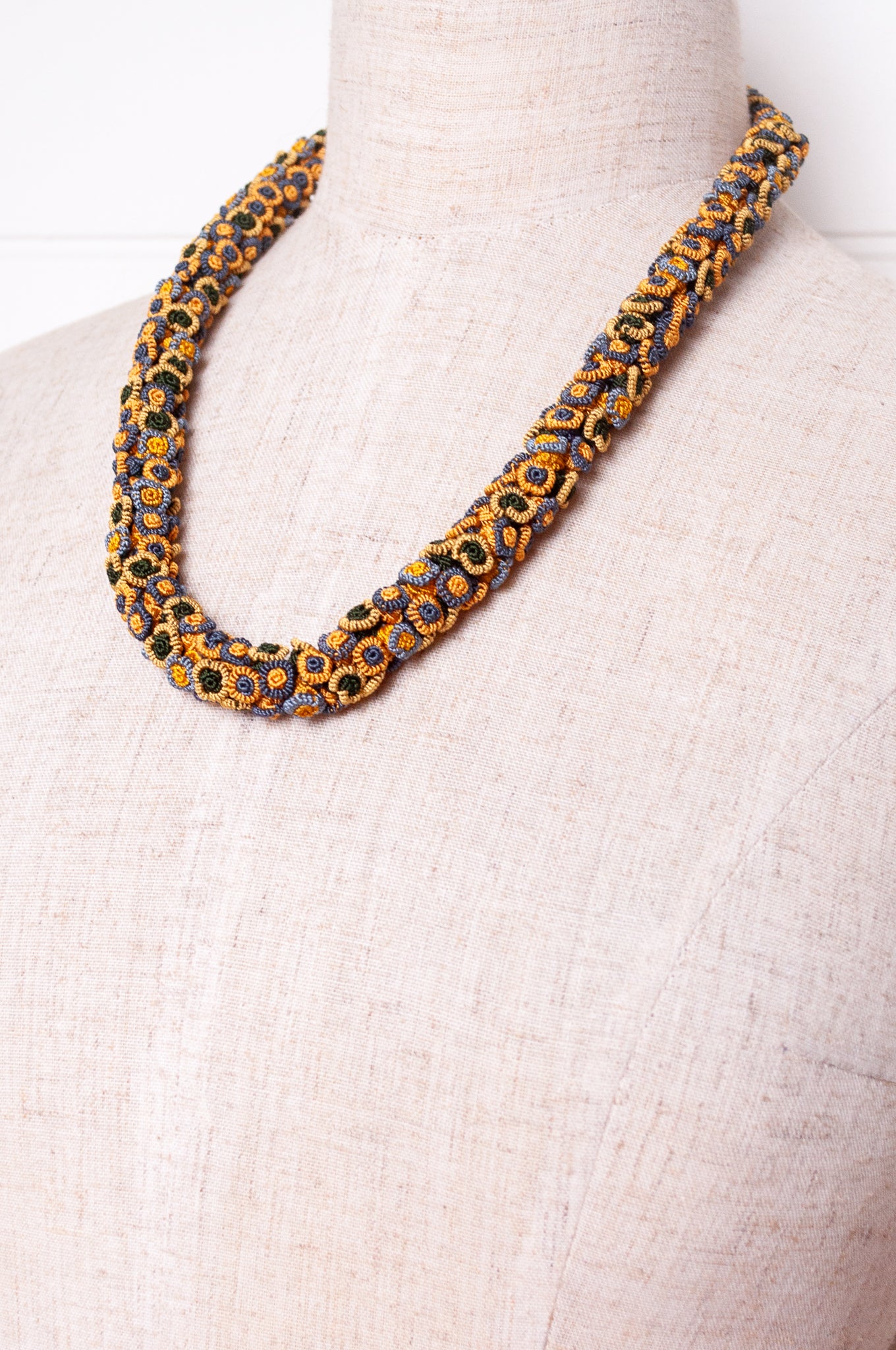 Moroccan flower button Oznati necklace in mustard yellow, latte and grey.