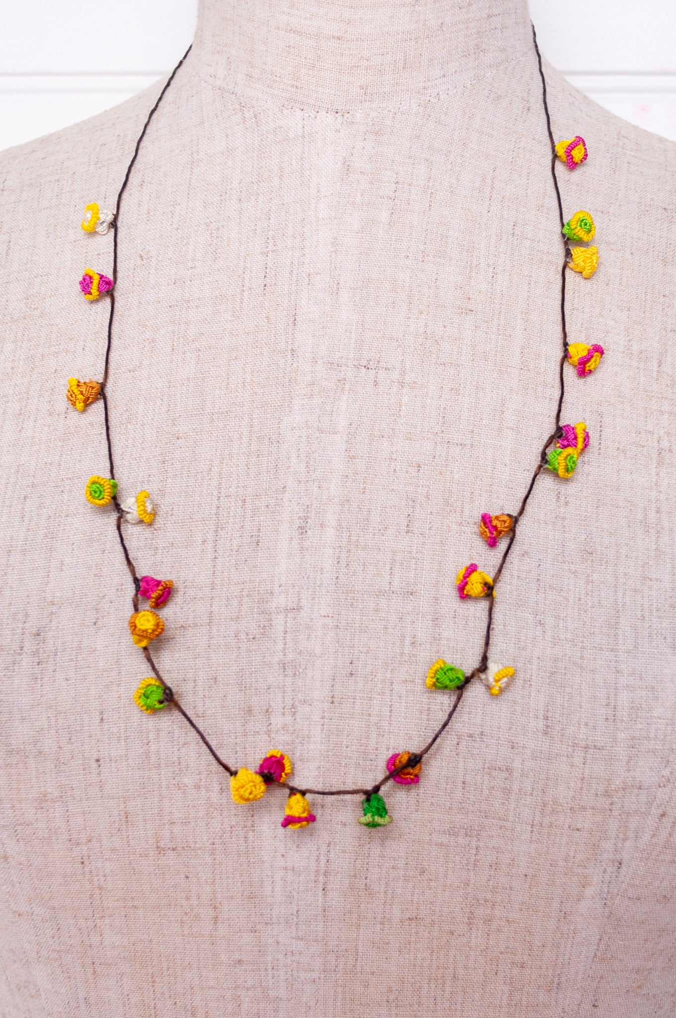 Handmade Moroccan button necklace in bright lemon yellow, rose pink and leaf green.