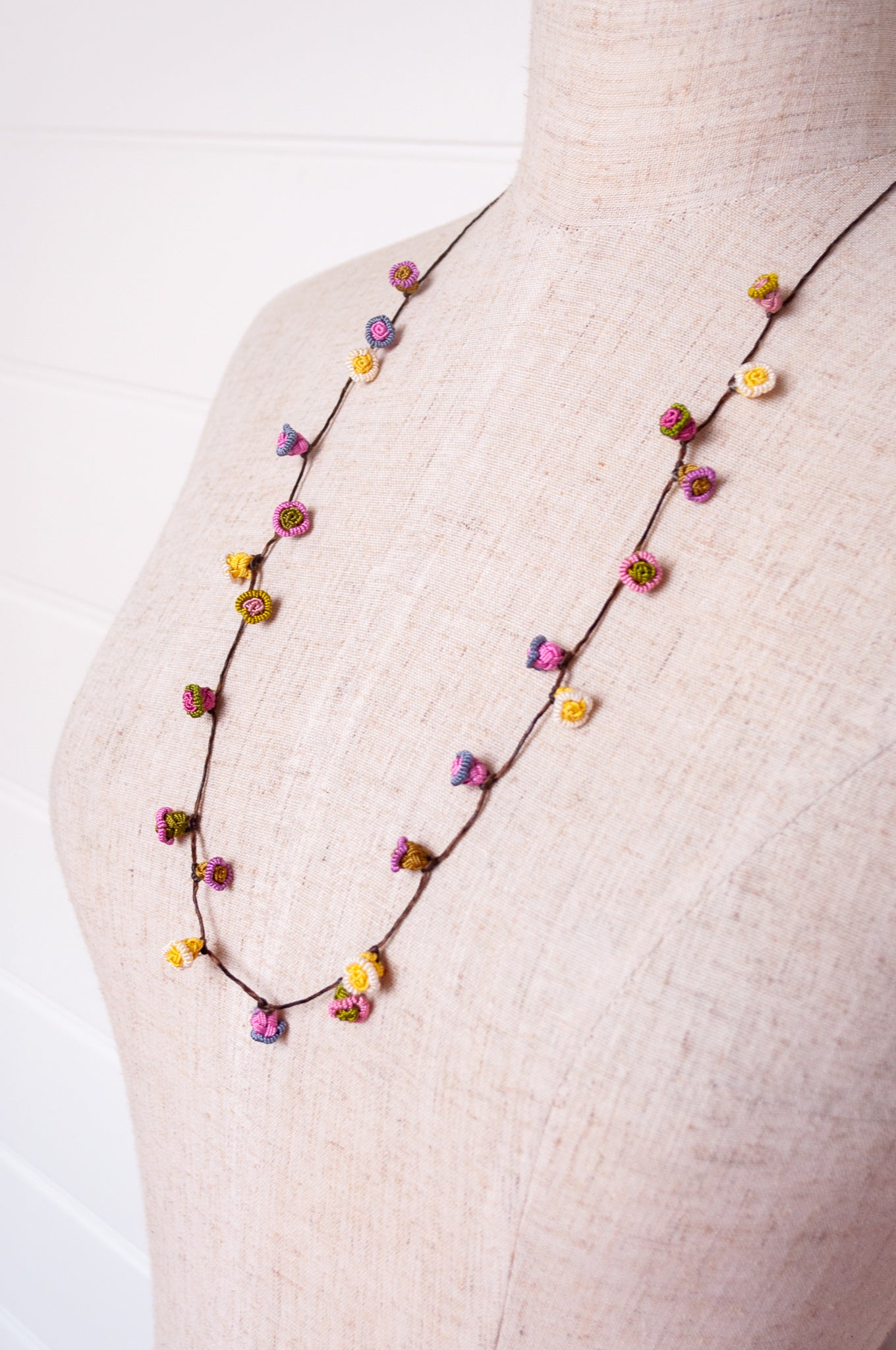 Handmade Moroccan button necklace in  soft pink, lemon and olive.