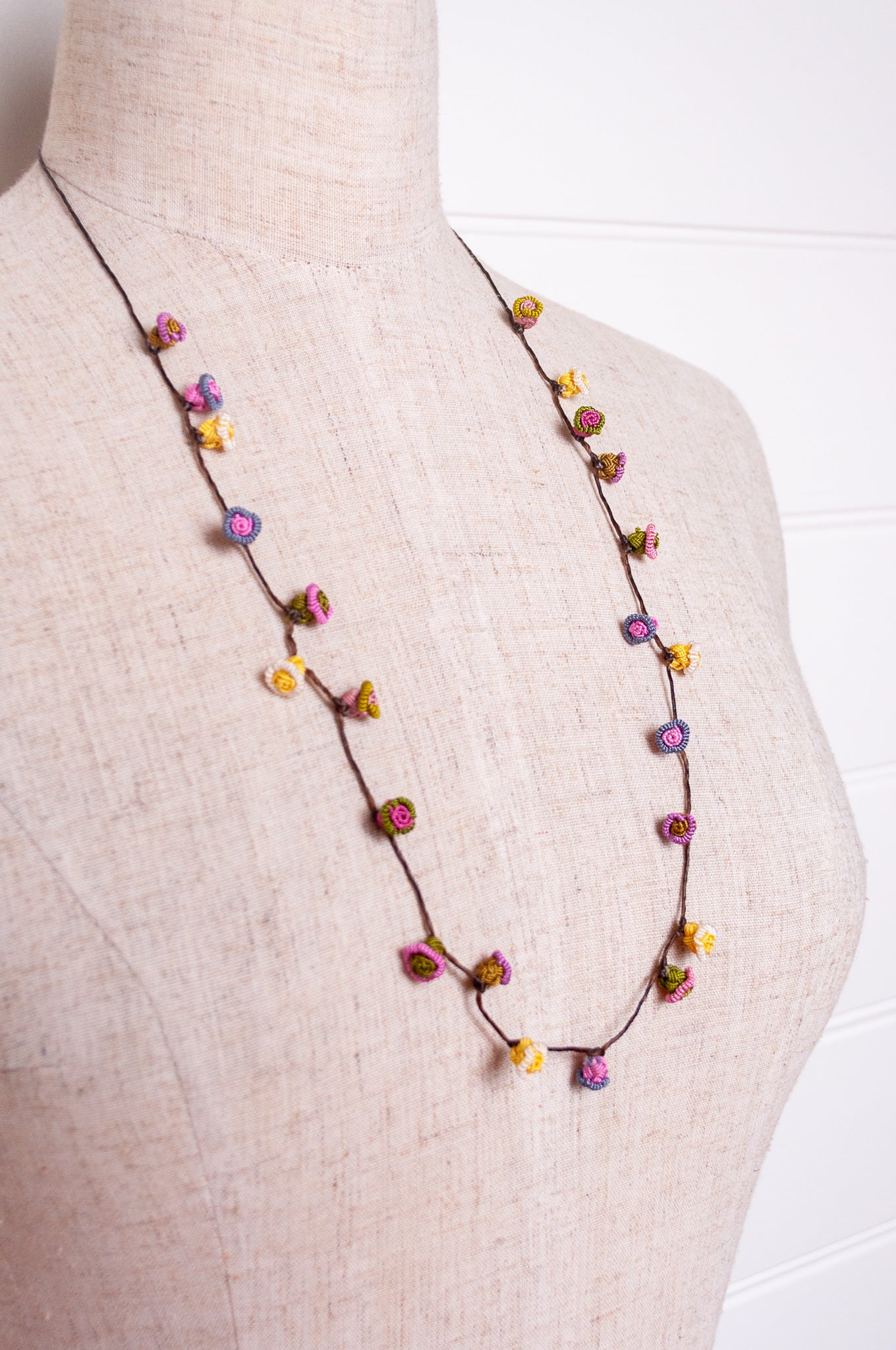 Handmade Moroccan button necklace in  soft pink, lemon and olive.