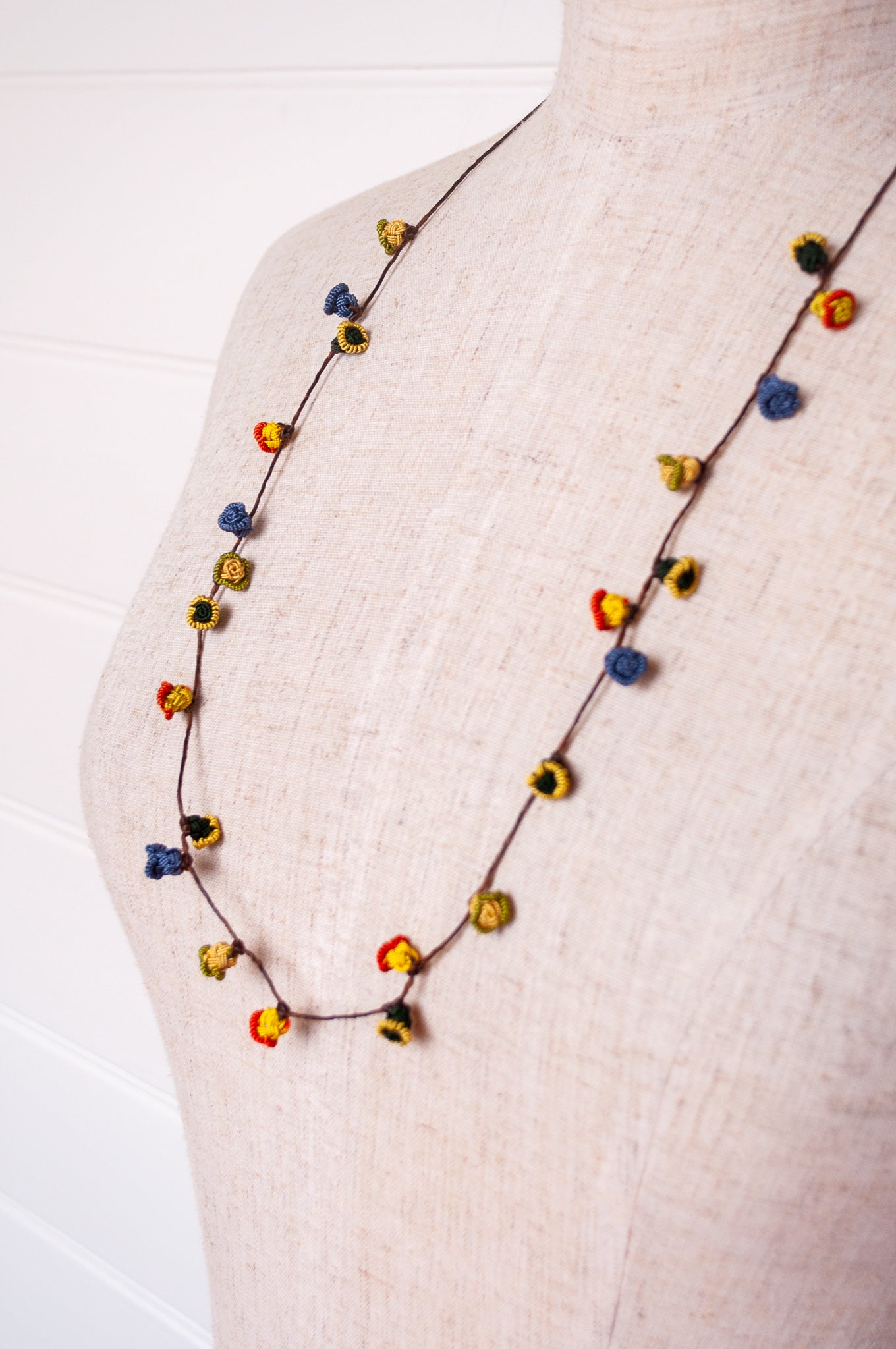 Handmade Moroccan button necklace in  blue, olive, mustard and pink.